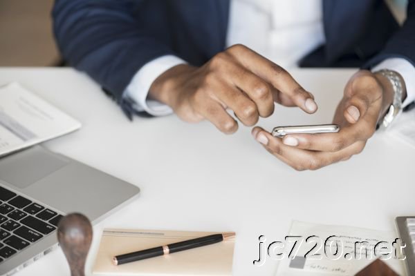 Person Holding Android Smartphone While Leaning on Table